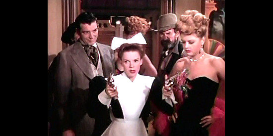 Judy-Garland-as-Susan-Bradley-armed-with-two-six-guns-goes-searching-for-stolen-steaks-in-The-Harvey-Girls-1946.jpg