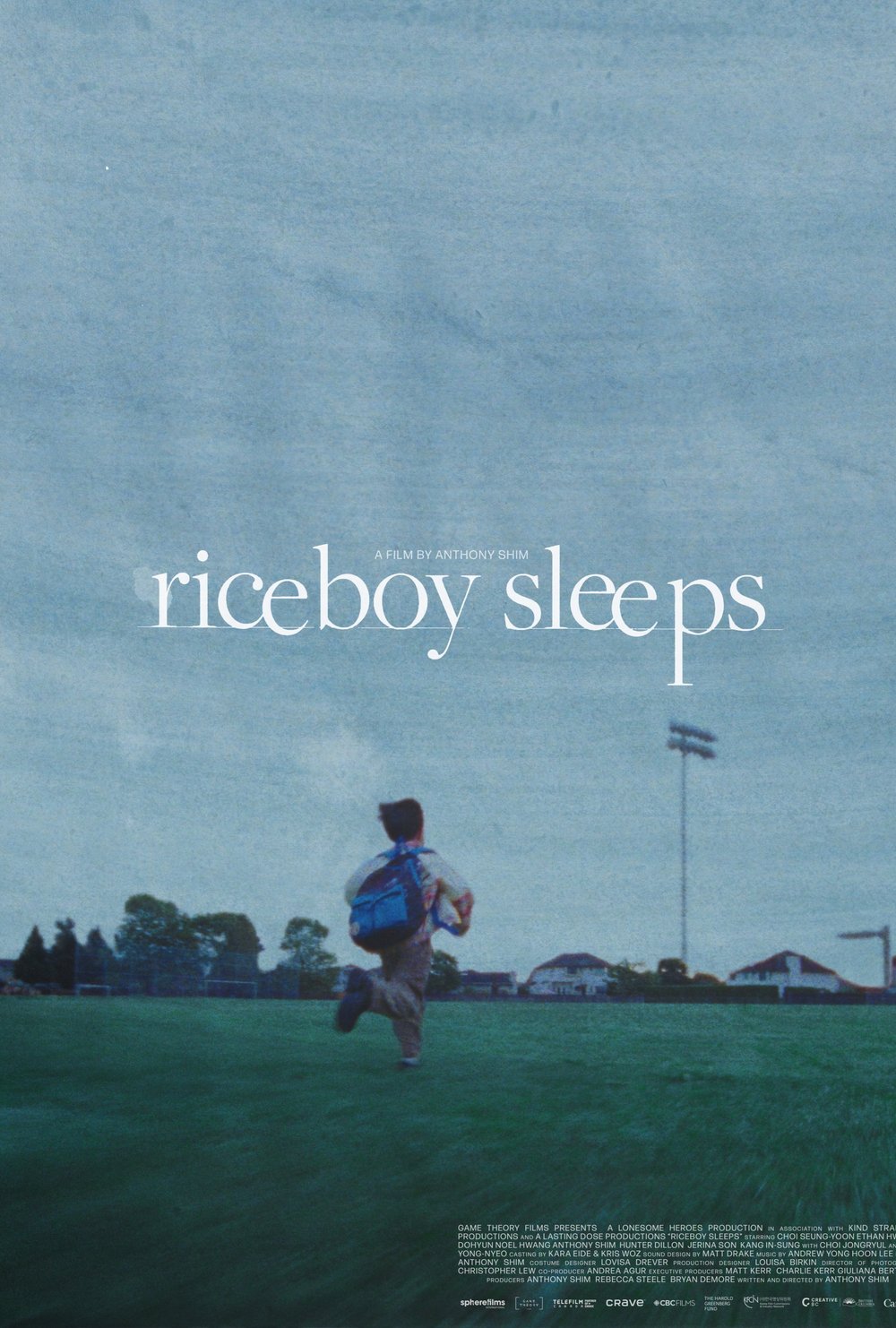 Riceboy-sleeps-film-poster-young-boy-running-through-field.jpg
