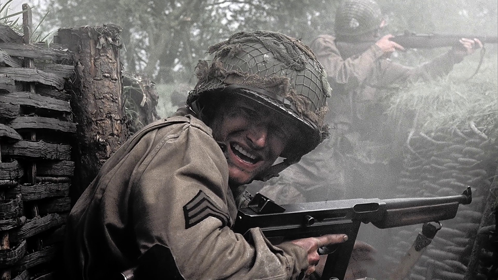 In Day of Days (Ep.2), Sgt. Joe Toye (Kirk Acevedo) points his Thompson at a Heer artillery man surrendering during the Brecourt Manor assault. Note that Toye's buttstock has been broken off by the stick grenade which detonated right b.jpg