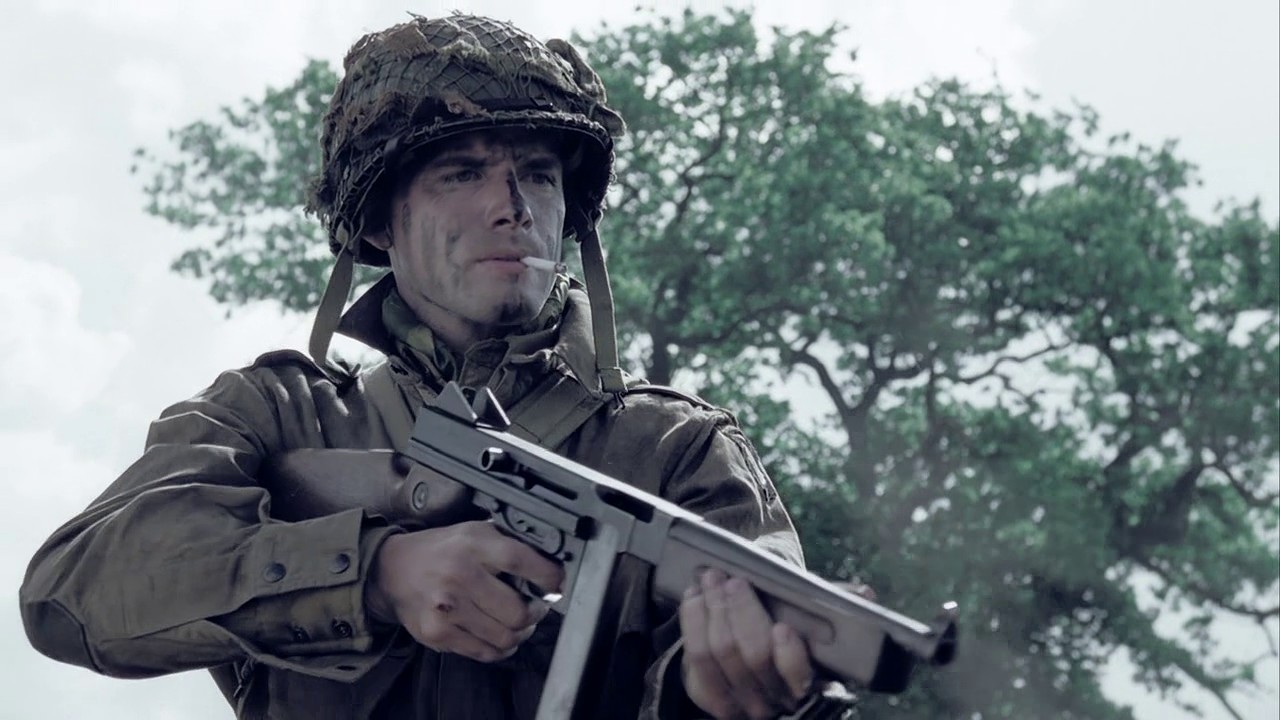 During a flashback scene in Carentan (Ep.3), Lt. Ronald Speirs (Matthew Settle) raises his Thompson M1A1 to execute a group of German prisoners. In the book Band of Brothers, a photo of the real Speirs shows him holding an M1928A1 Tho.jpg