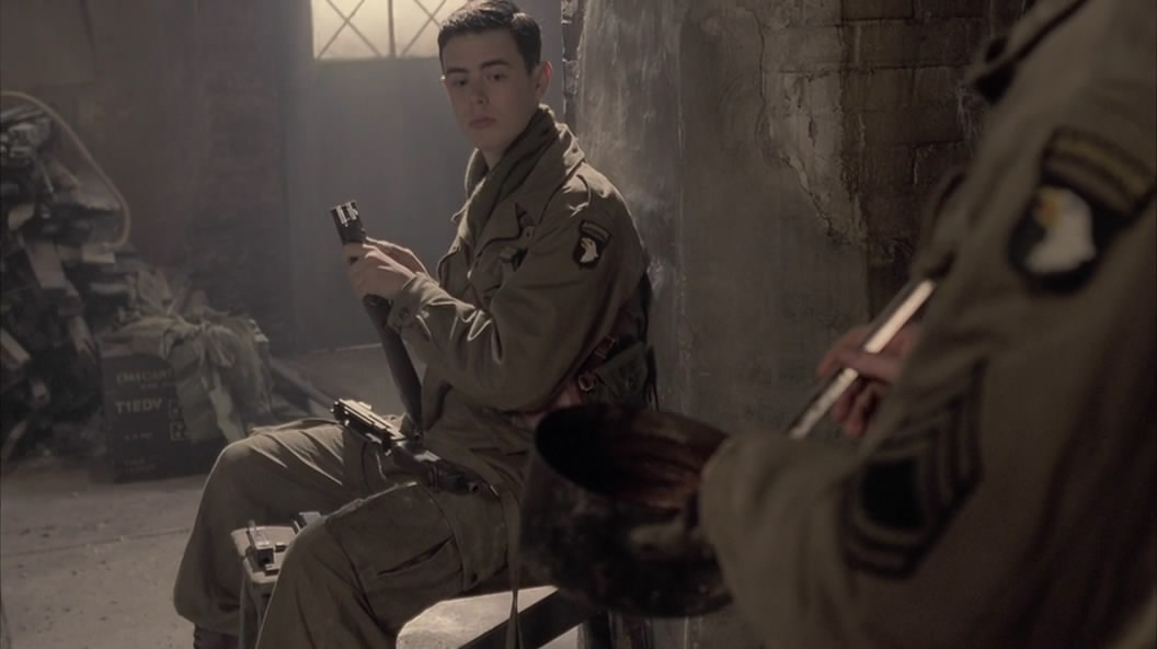 Lt. Jones (Colin Hanks) cleans his Thompson before a mission in The Last Patrol (Ep.8)..jpg