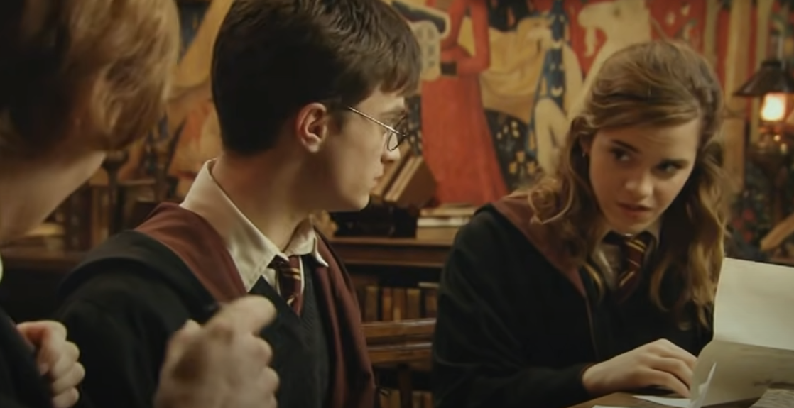 Harry_Potter_Hermione_Granger_and_Ronald_Weasley_read_the_letter_from_the_Queen's_Palace.png