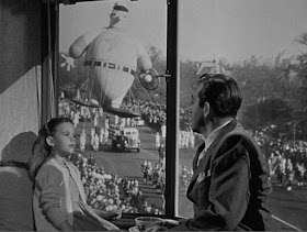 natalie-wood-and-john-payne-watching-parade.jpg